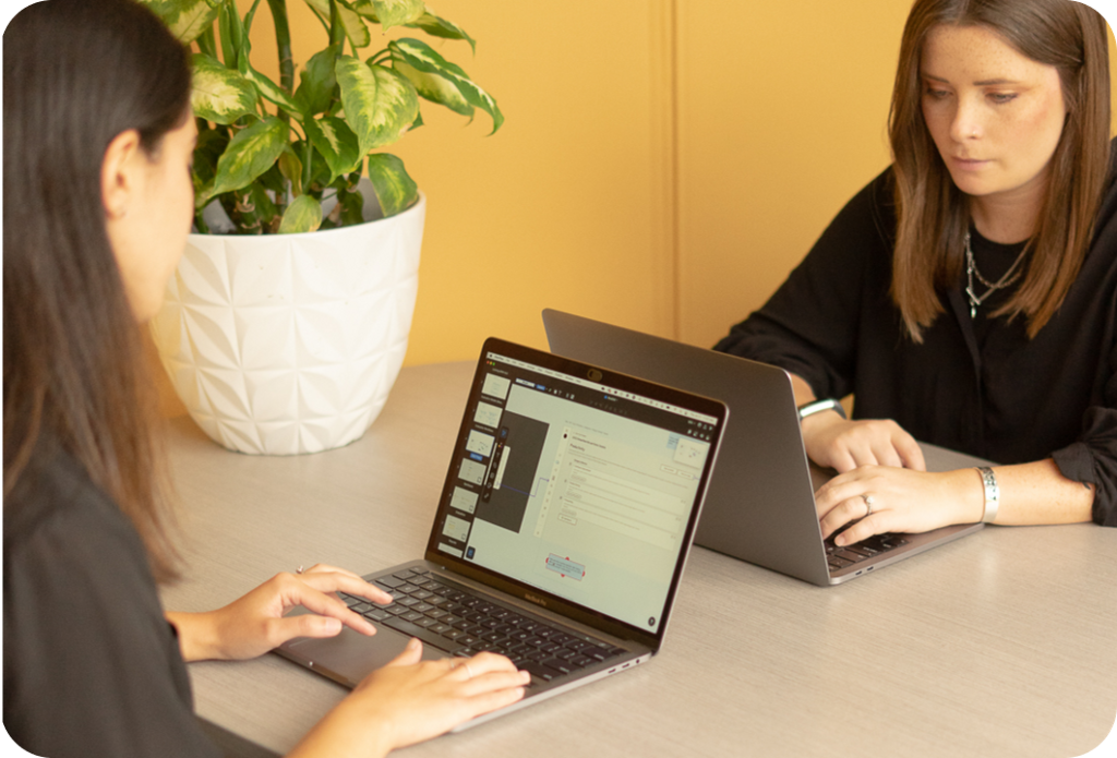 The two designers working on their laptops in the Orange Bees office.